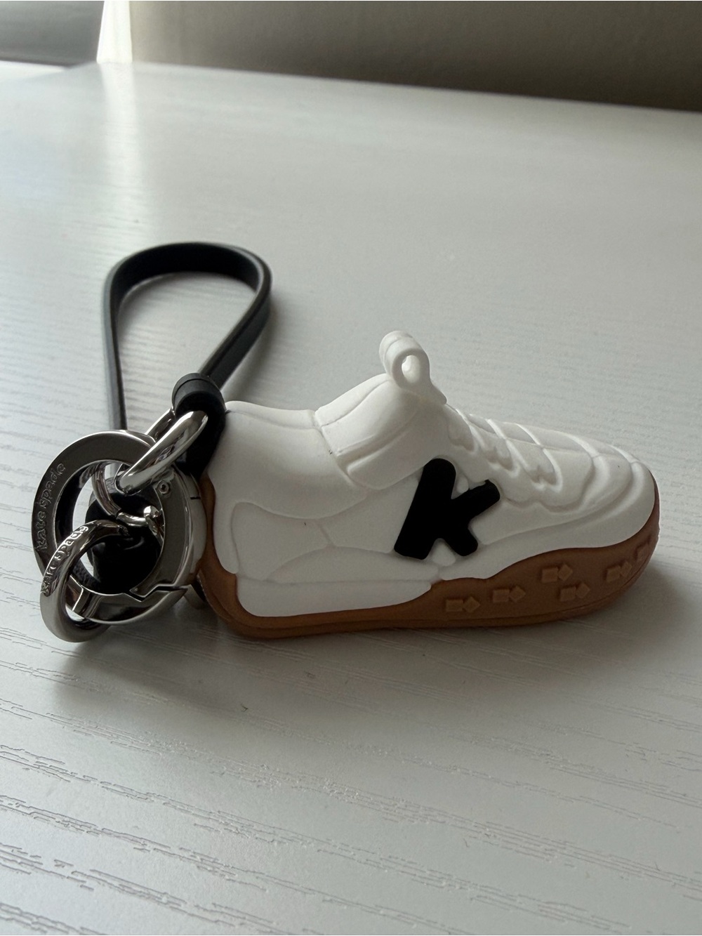 Kate Spade White Sneaker bag charm with Black Accent